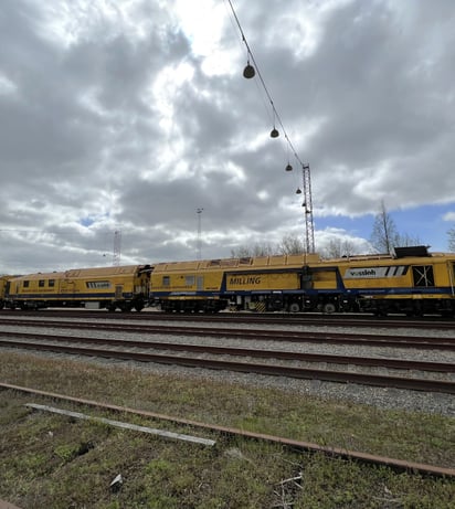 Milling train SF03 on tracks, cloudy sky
